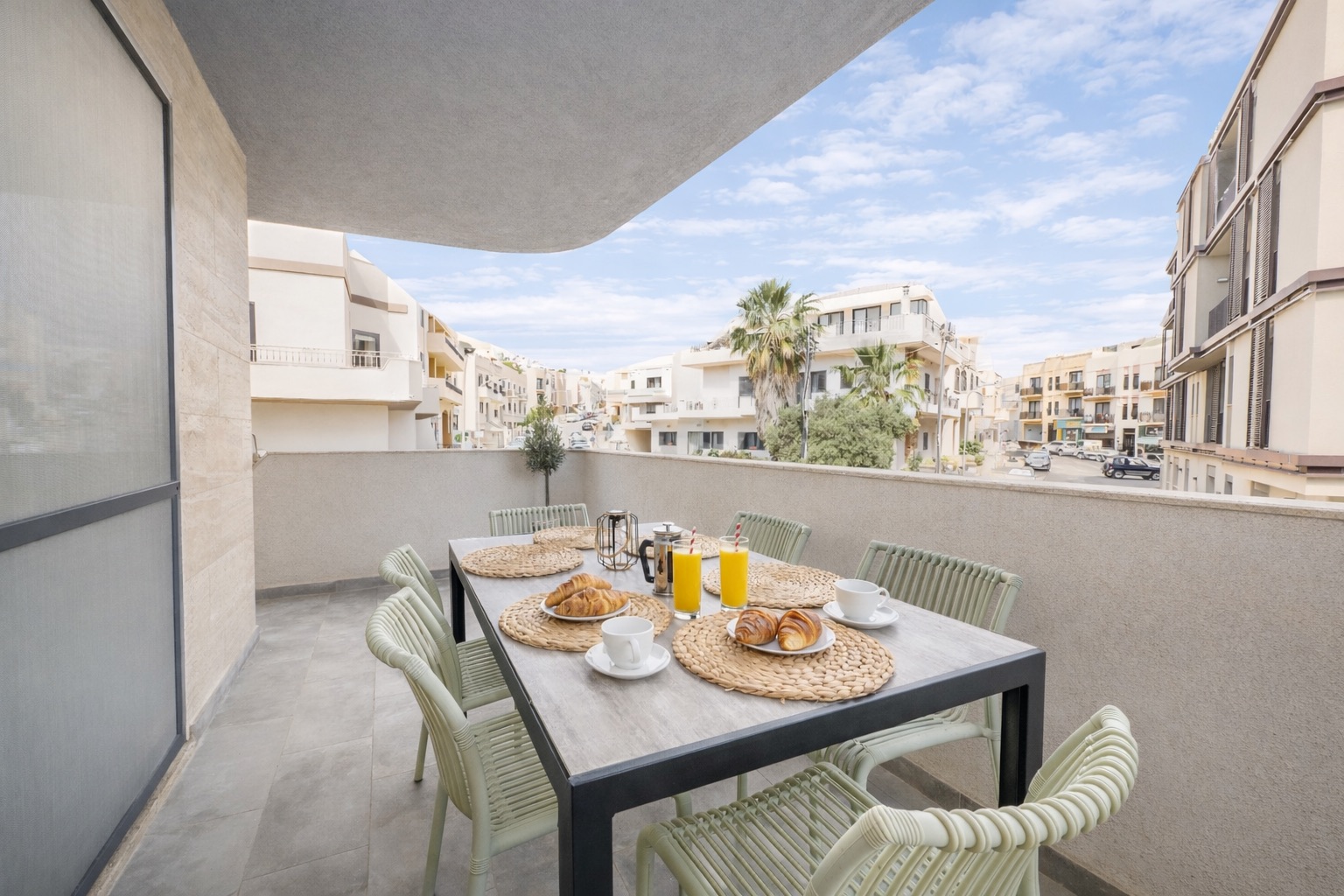 Sunny terrace with dining table set for breakfast